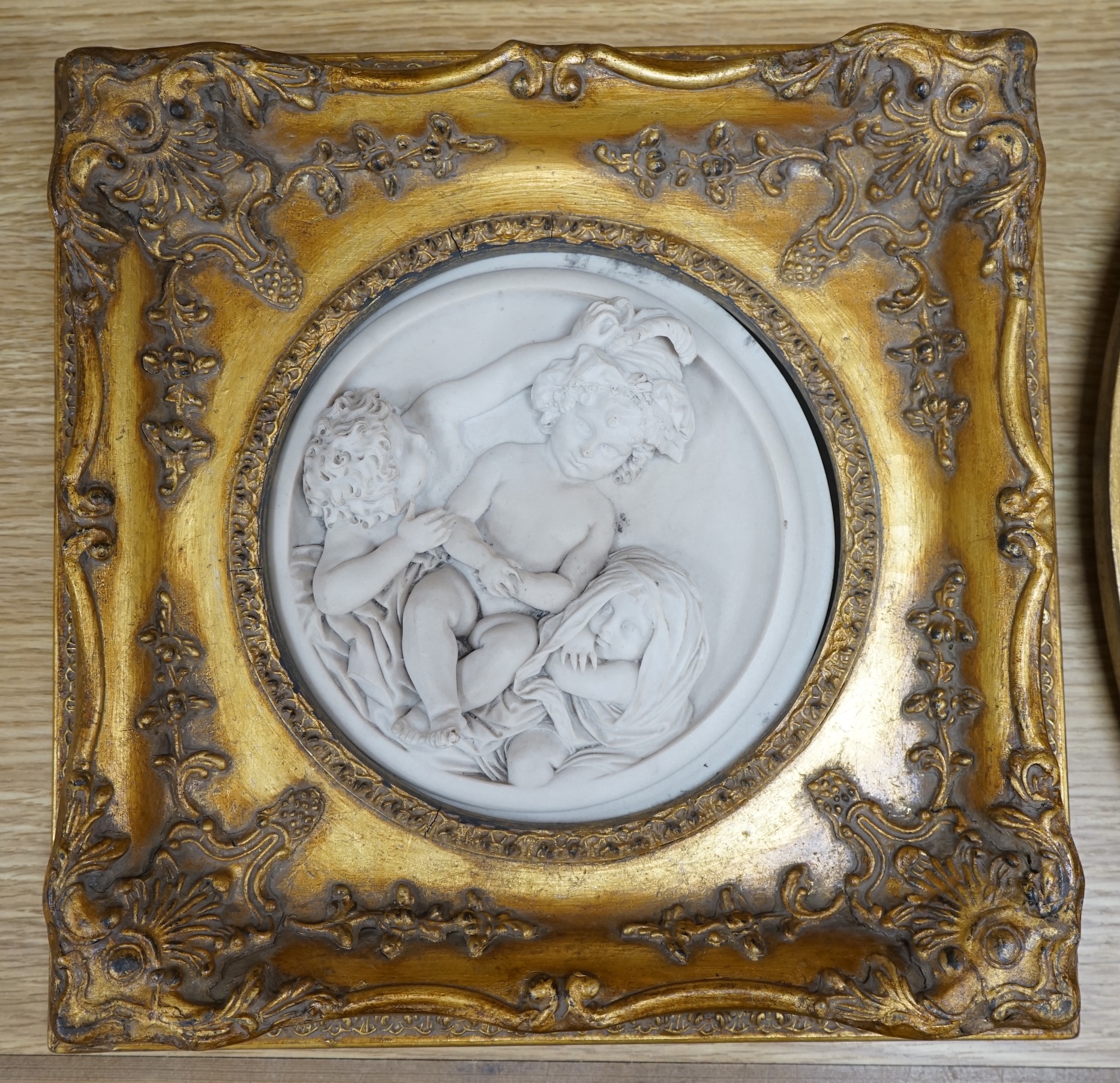 A pair of framed faux marble plaques and a similar oval plaque. Condition - good